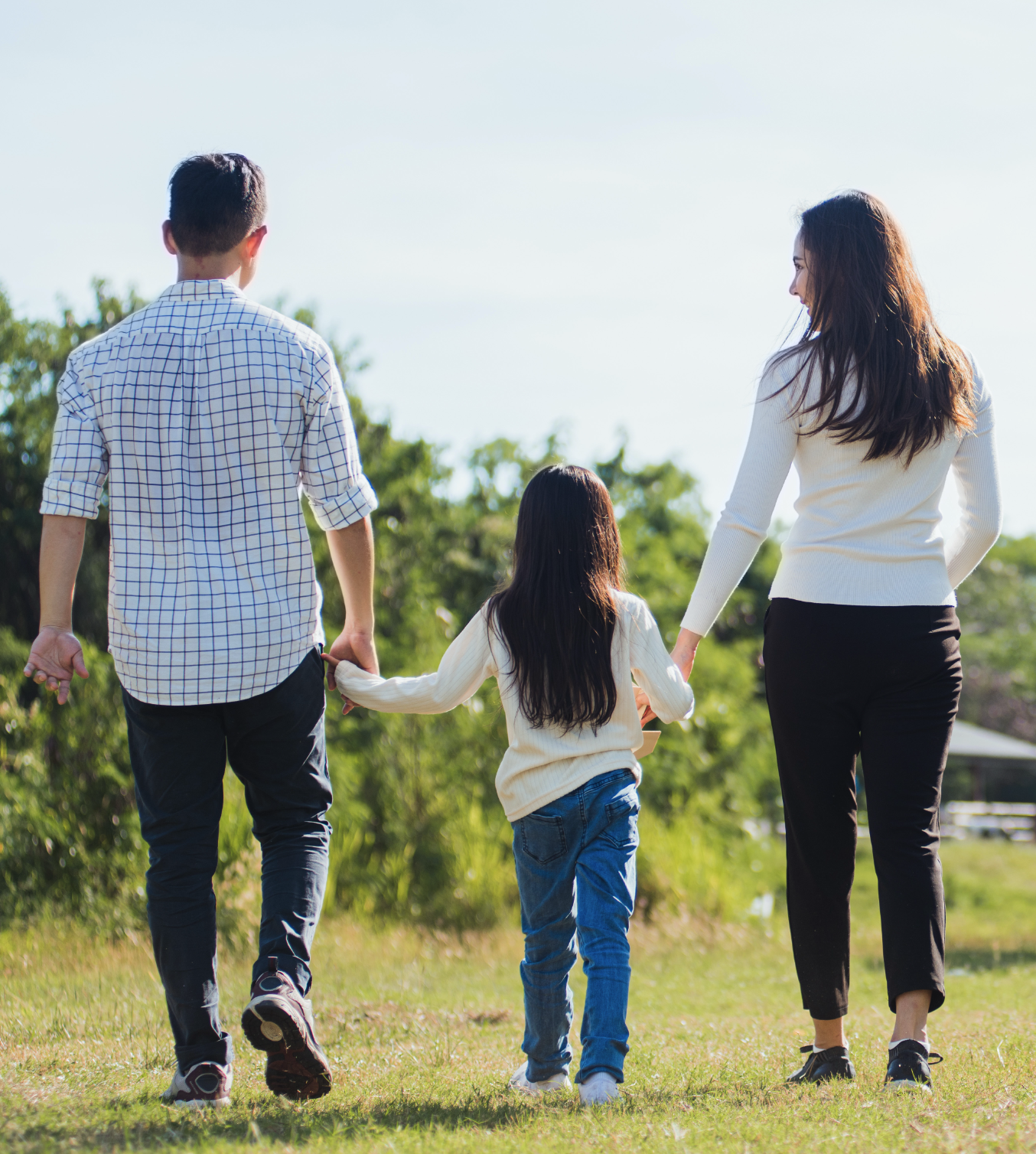 Family walking in green field